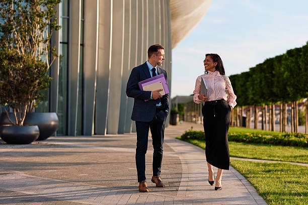 Two business professionals in conversation outside an office — Careers Ninza partnership programs
